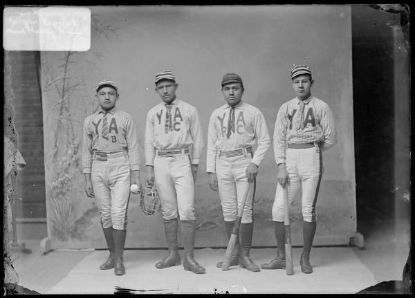 Four young men in baseball uniforms, c.1889