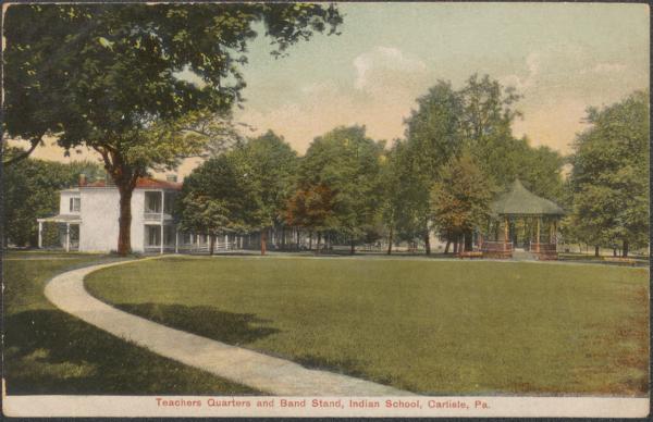 color image; view from the superintendent's quarters looking north showing the path to the teacher's quarters and the band stand