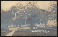 a real photo postcard, sepia-toned view of Carlisle School administration building, there are two trees slightly obscuring the view