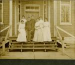 Seven students on steps of building [version 2], c.1900