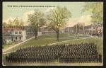 color image; view of the school grounds from perspective of the academic building towards the quarters, leaves have been painted onto the trees, in the foreground is a set of students arranged in tight rows (they have not been painted in post-production), the sky is a light teal colo