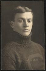 real photo postcard; portrait of a young man (Frank Mt. Pleasant going by the caption), his hair is cut short and he is wearing a high turtleneck knit sweater with a "c" design on the front