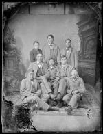 Seven male Crow students with John Nisely [version 1], c.1890