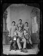 Four male students with two small white boys, c.1885