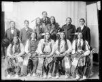 Seven visiting chiefs with two older Native American men and three male students, c.1890