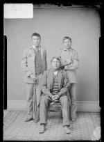 Native American man with two male students, c.1882