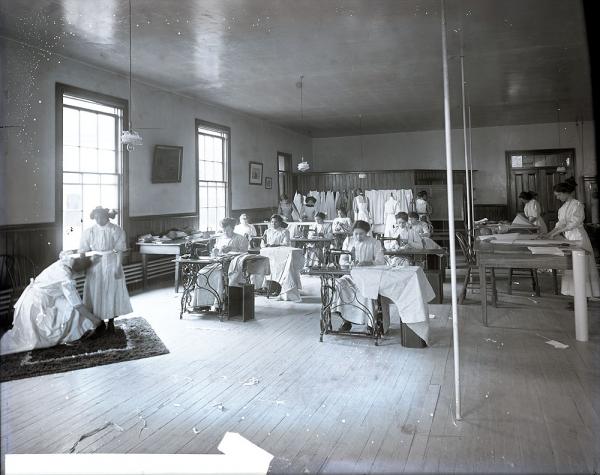 Female Students Fitting, Cutting, and Sewing Clothes, c. 1910