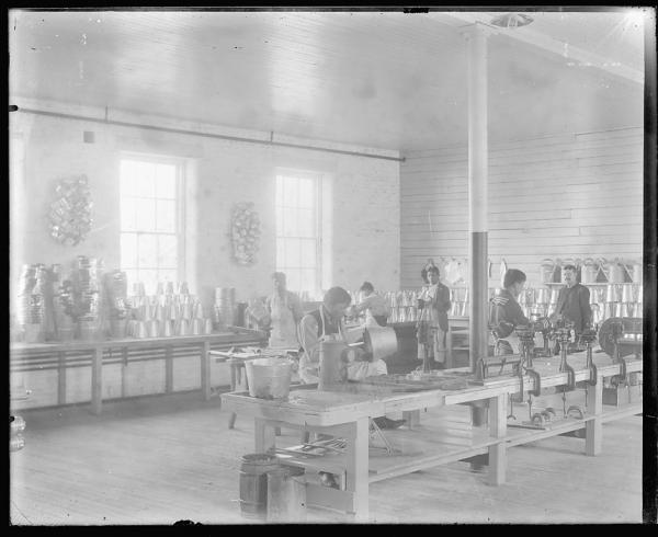 Students working in the tin shop with instructor, c.1881