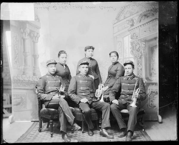 Three male student band members and three female students, c.1890