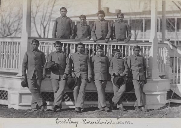Ten male Creek students posed at the bandstand [version 2], 1881