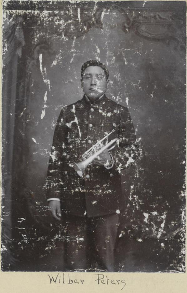 Wilbur Peters holding cornet, c.1896
