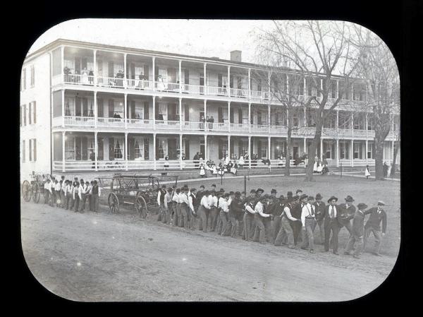 Male Students with Fire Engine Outside Girls' Quarters, c. 1900