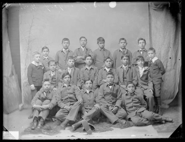 Seventeen unidentified male students with two white boys, c.1887