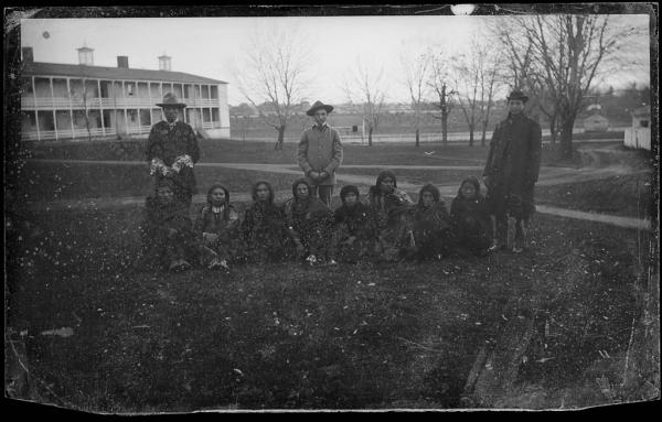 Three male students with eight students who have just arrived, c.1883