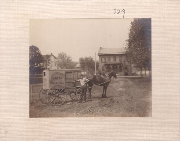 James B. Driver with bread cart, c.1910