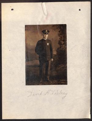 Selections from Personnel Folder of David H. Dickey photograph of man labelled "David H. Dickey," man is in dark uniform with hat in front of painted backdrop