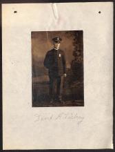 photograph of man labelled "David H. Dickey," man is in dark uniform with hat in front of painted backdrop