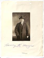 photograph of light-skinned man captioned with "Harvey K. Meyer," Meyer wears an overcoat and hat