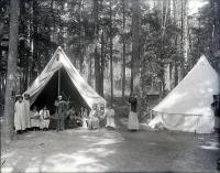 Female students with bow and arrow and rifle at Camp Sells, c. 1913