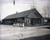 Female Students with Laundry Baskets Beside Laundry Building, c. 1910