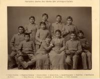Studio portrait of eight male and three female students, all wearing school uniforms. 