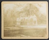 Eight female students posed on a bridge in the woods, c.1894