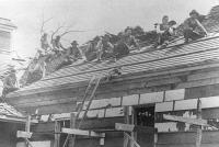Indian School students and staff working on roof of a building, 1880