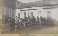 Tin shop interior with student apprentices, c.1882
