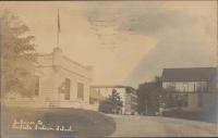 real photo postcard; view of art studio/alumni hall in the left foreground, a wing of the dining hall, the laundry, and corner of large boys' quarters are visible in the background