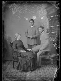Two male students with a white woman, c.1885
