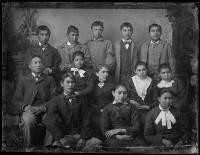 Twelve unidentified students with a female teacher, c.1882