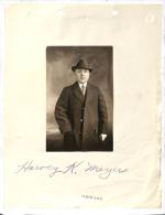 photograph of light-skinned man captioned with "Harvey K. Meyer," Meyer wears an overcoat and hat