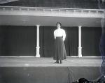 Female student on a stage, c. 1910
