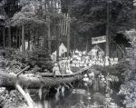 Female Students Sitting on Log Bridge at Camp Sells, c. 1913