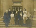 Nine students with two teachers on court house steps, c.1900