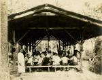 Male students and staff in the dining pavilion at Camp Sells, c. 1913