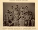 Studio portrait of eight male and three female students, all wearing school uniforms. 