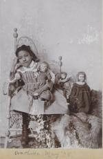Wacheka High Dog posed with dolls, 1895