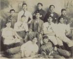 Twelve male students with baseball equipment, c.1895