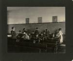 Four Students Writing on Blackboard in Classroom, 1901