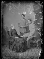 Two male students with a white woman, c.1885