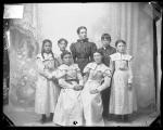 Five female students, one male student, and a female teacher, 1897