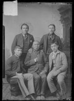 Three Native American men with two students, c.1890