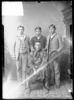 Osage chief with three male students, c.1891