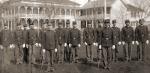 Fifteen male students in uniform on school grounds, c. 1912